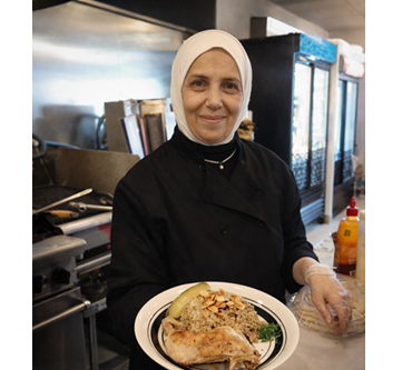 Shawerma Plus chef presenting a freshly prepared meal