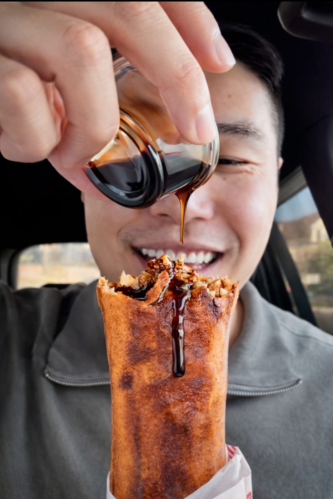 Guest enjoying a shawarma wrap with pomegranate syrup