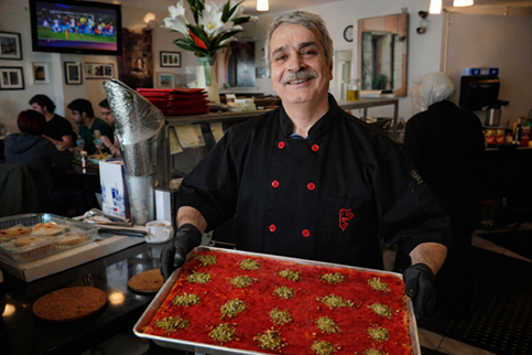 Chef and founder Asem presenting freshly made kunafeh