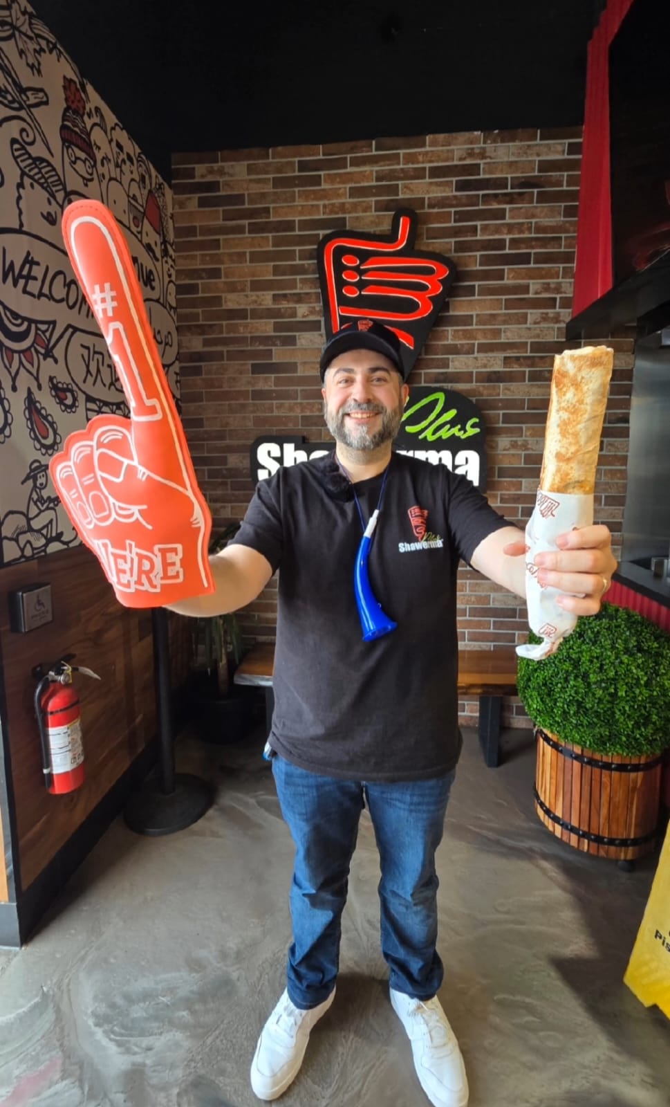 Award-winning chef holding a freshly made saj wrap